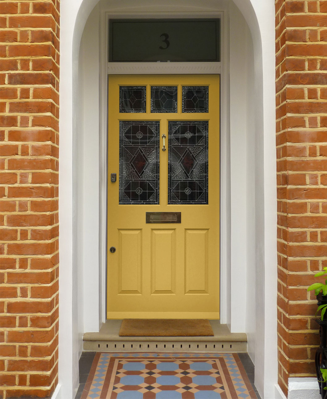 Yellow 'Honey' Edwardian door featuring decorative glass panelling and brass door furniture.